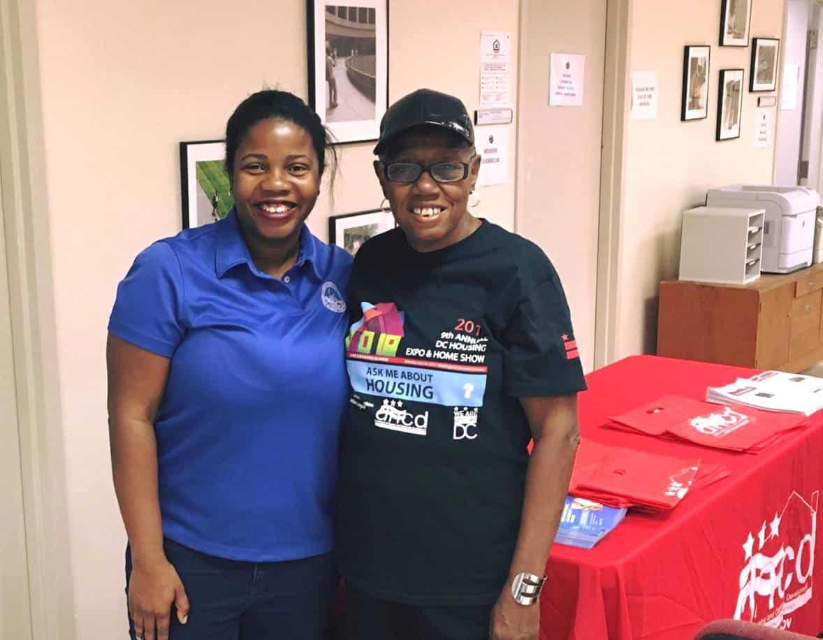 two black women at a volunteer table