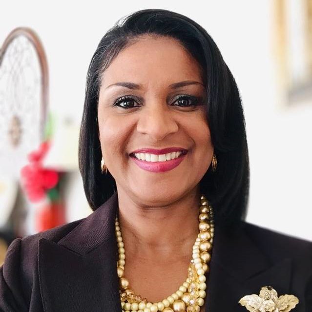 black-american woman in business attire smiling