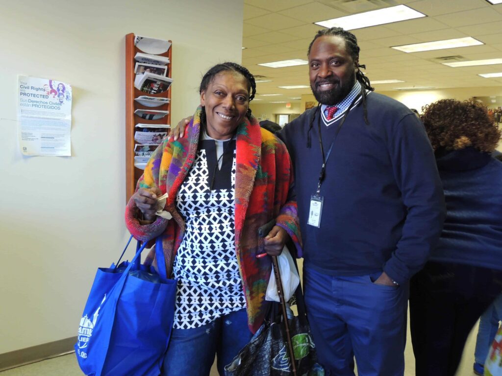 black american man and woman holding a bag containing a turkey