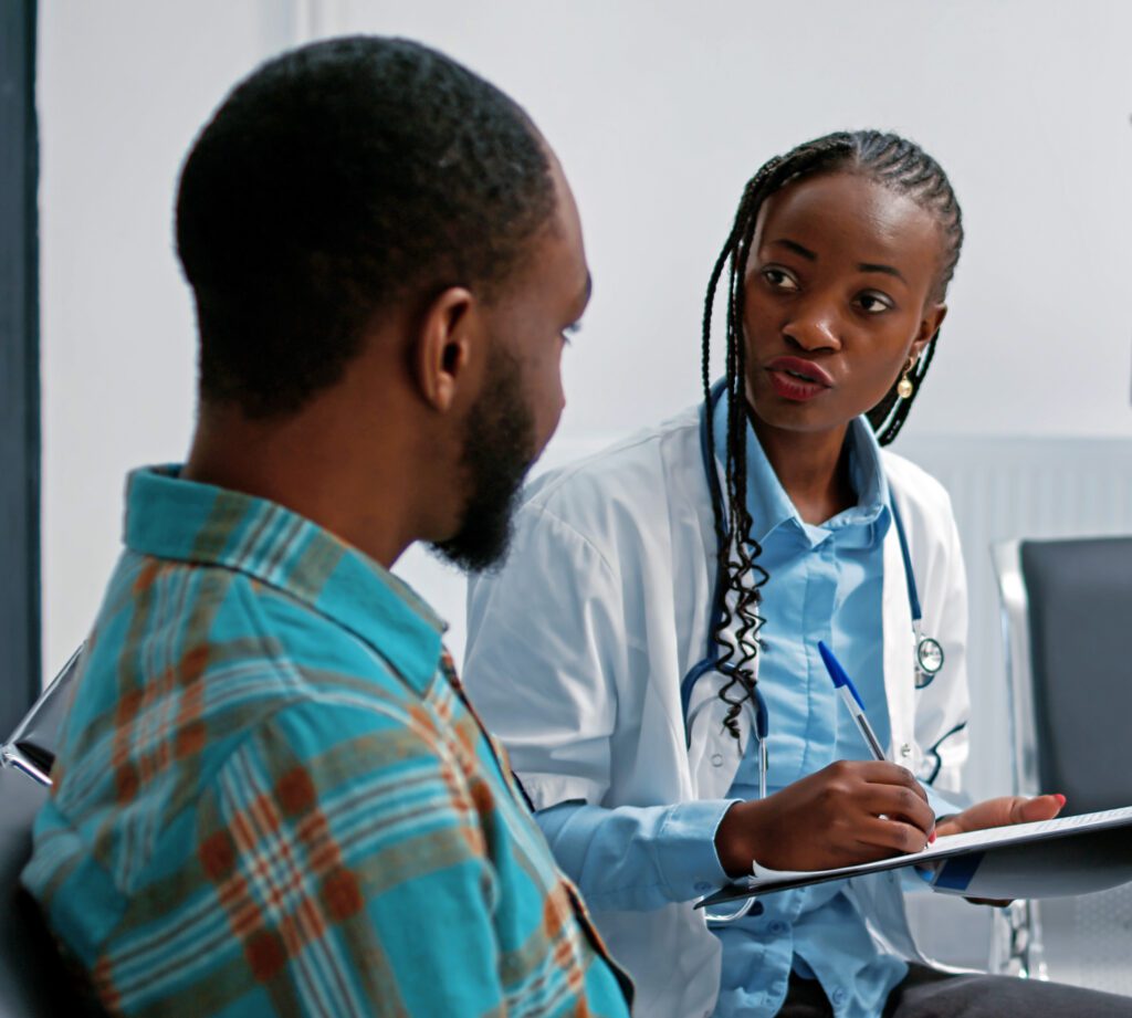 African american specialist and patient doing consultation in waiting area at hospital reception lobby