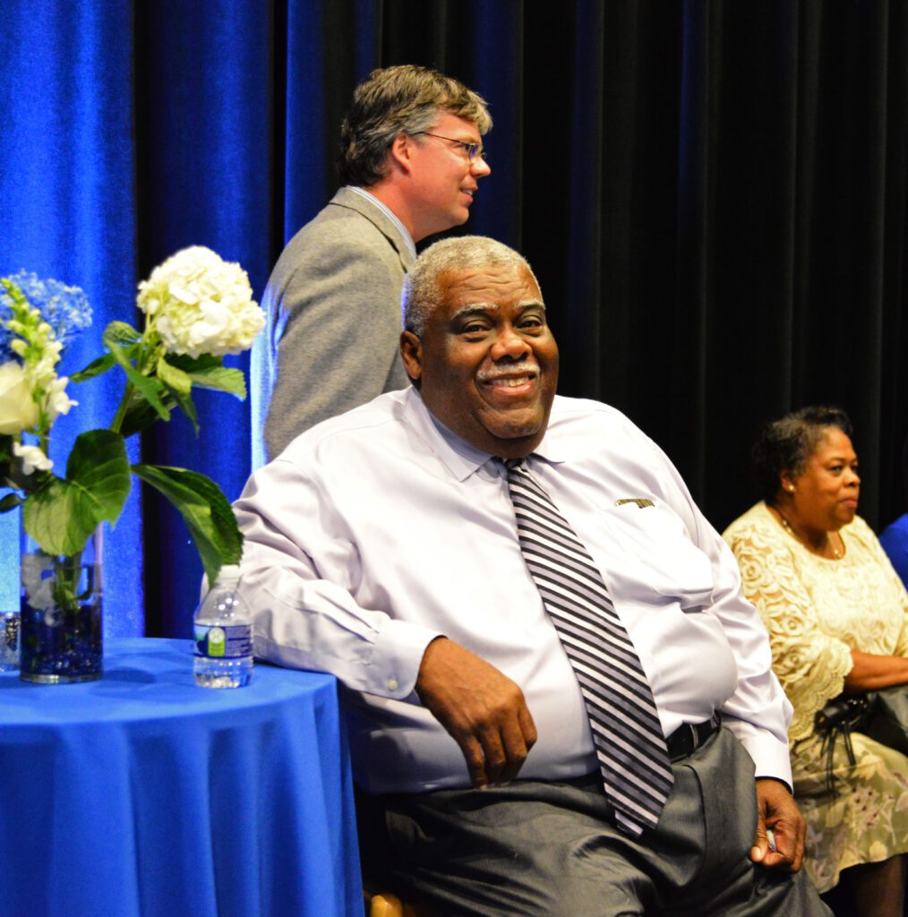 Man sitting at a table and smiling