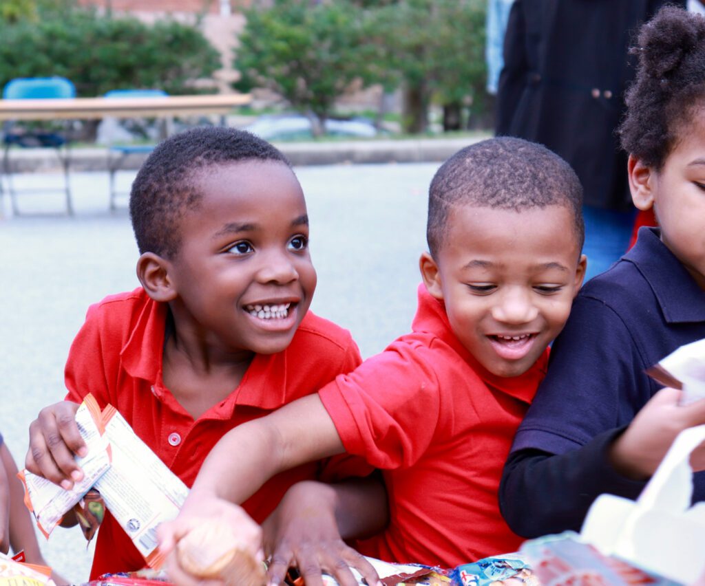 Children excitedly grabbing snacks