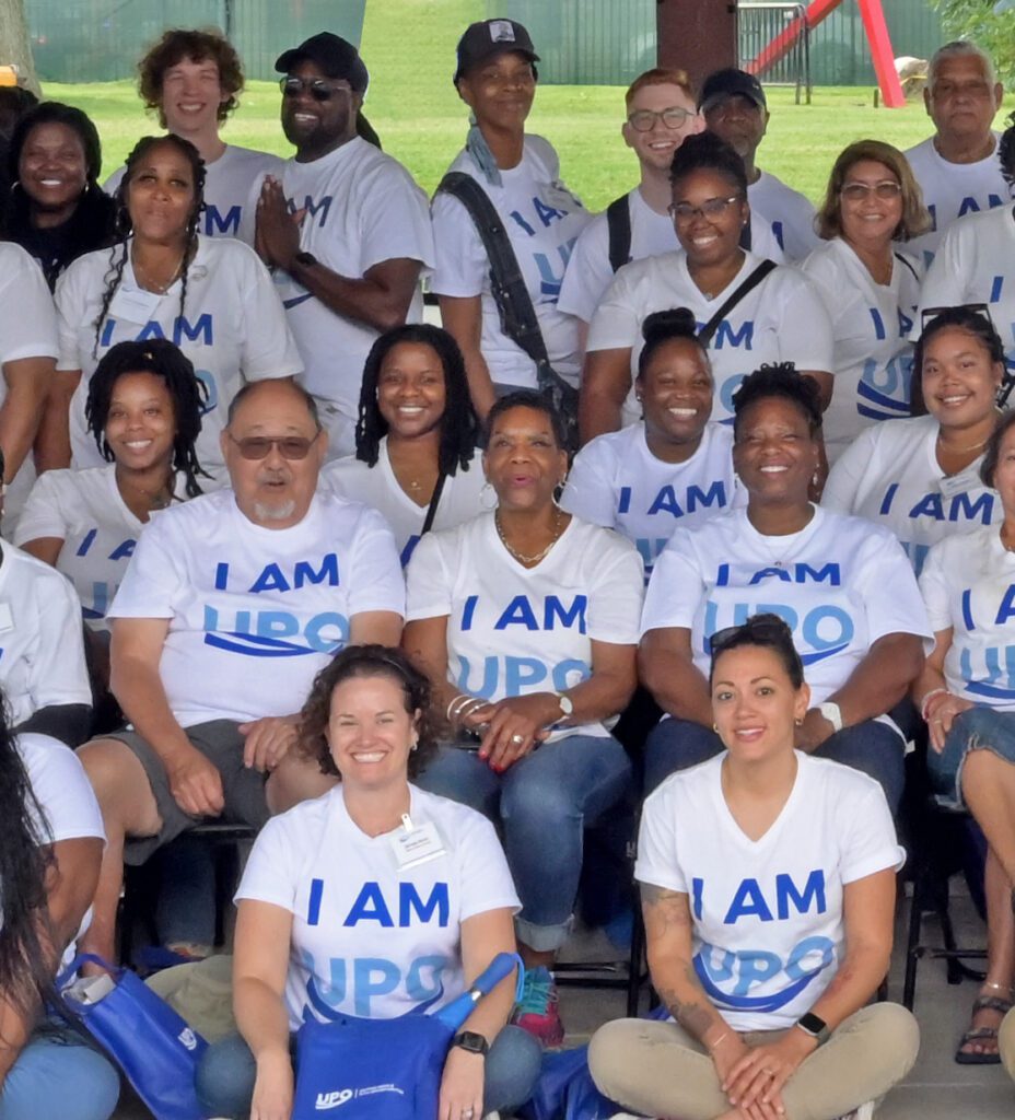 Group of people wearing I AM UPO shirts