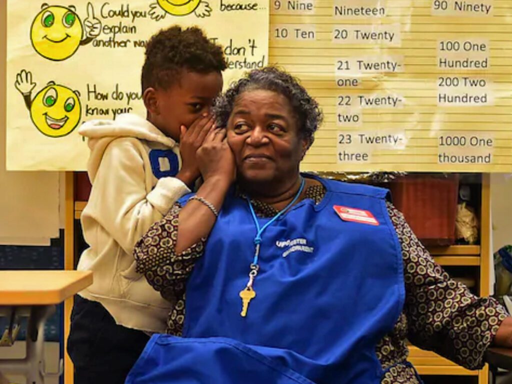 Child whispering into a UPO worker's ear