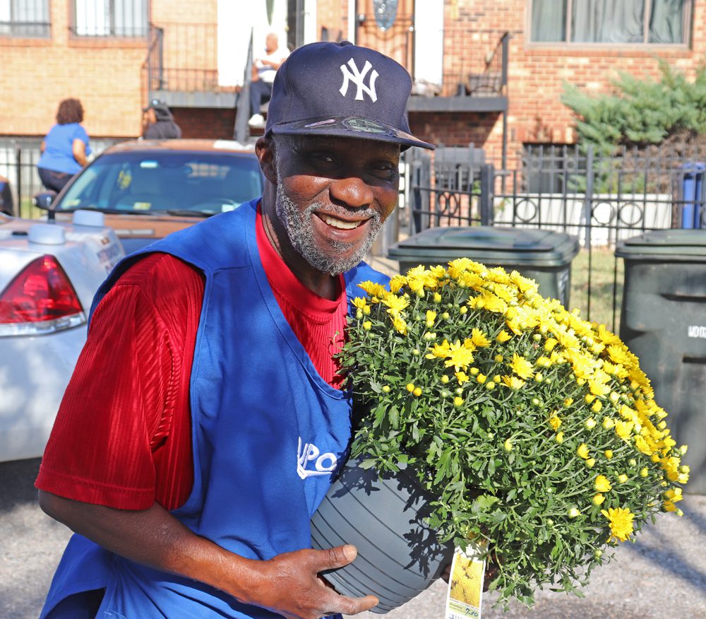 UPO worker holding a pot of flowers