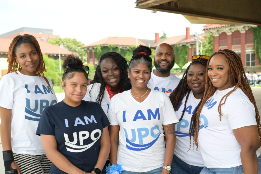 Group of people wearing "I am UPO" shirts