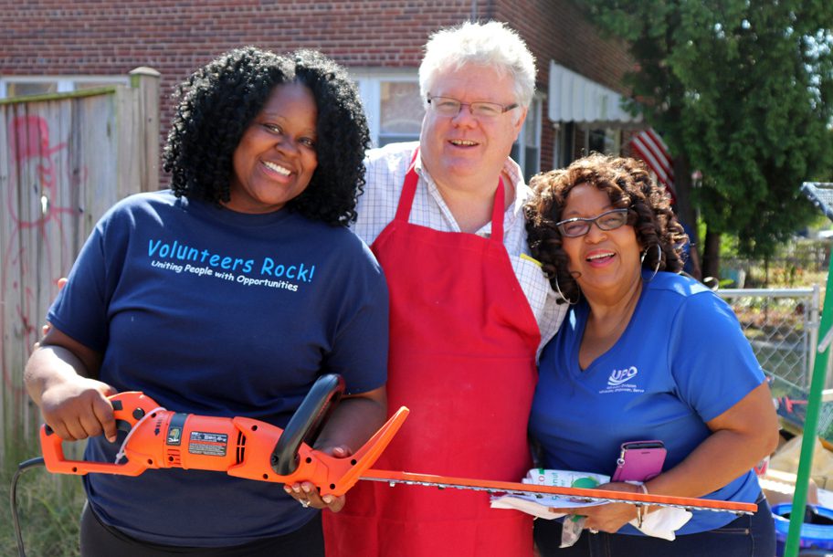 3 UPO workers and volunteers smiling