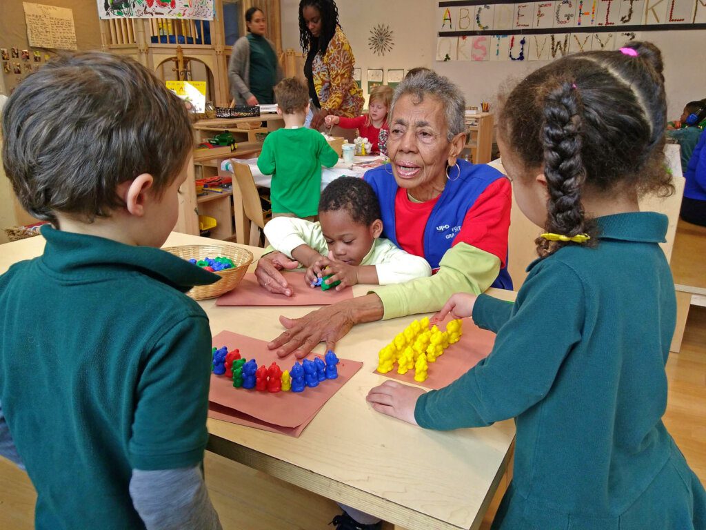 UPO foster grandparent playing with children