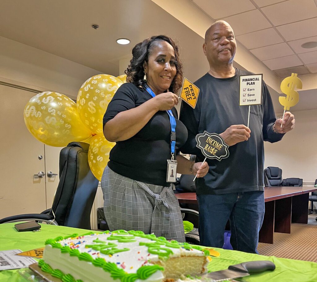 Kimothy James and Victoria Clayborne at a celebration with a cake