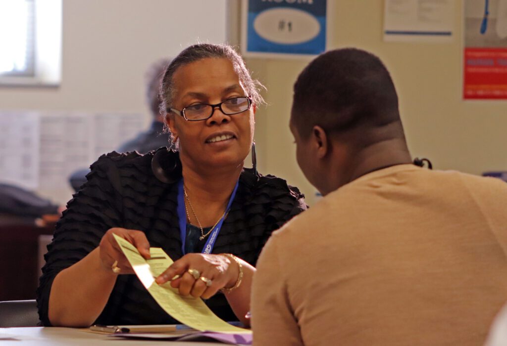 Woman pointing out something on a form to a man