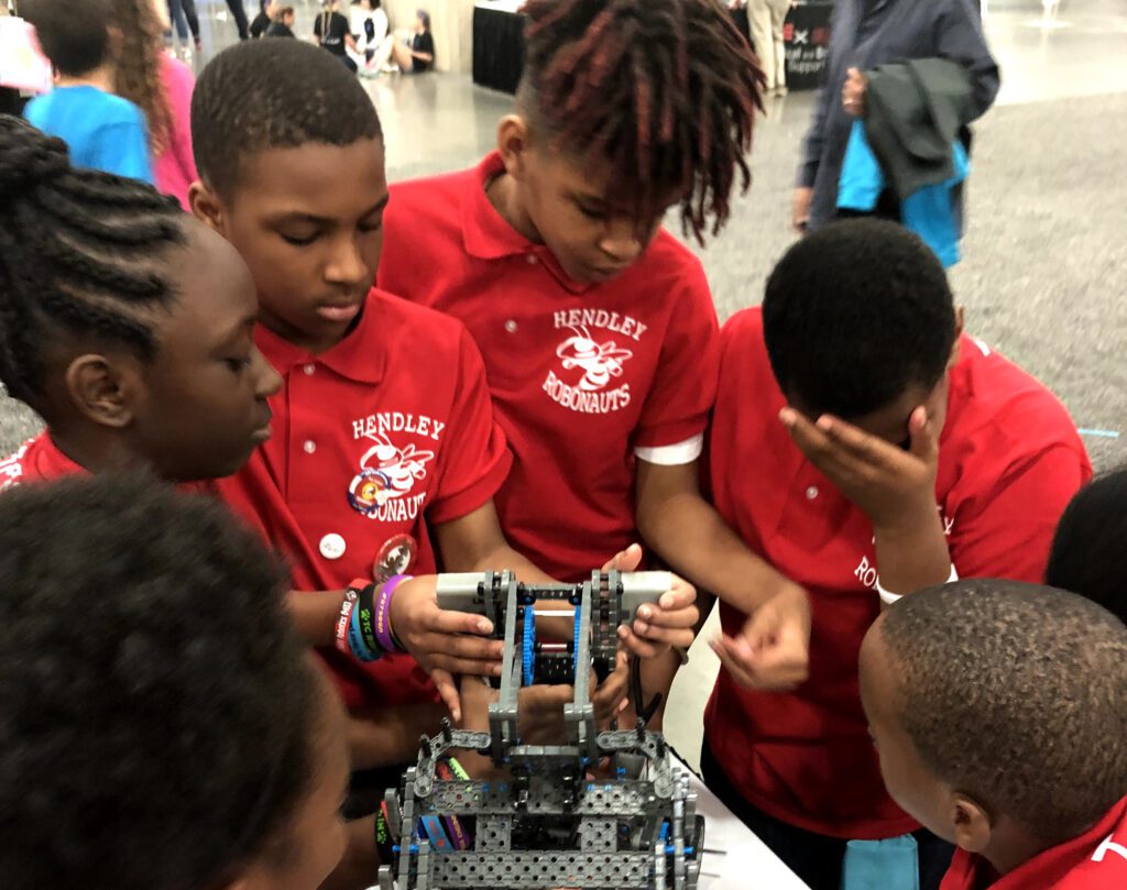 Group of children around their robot