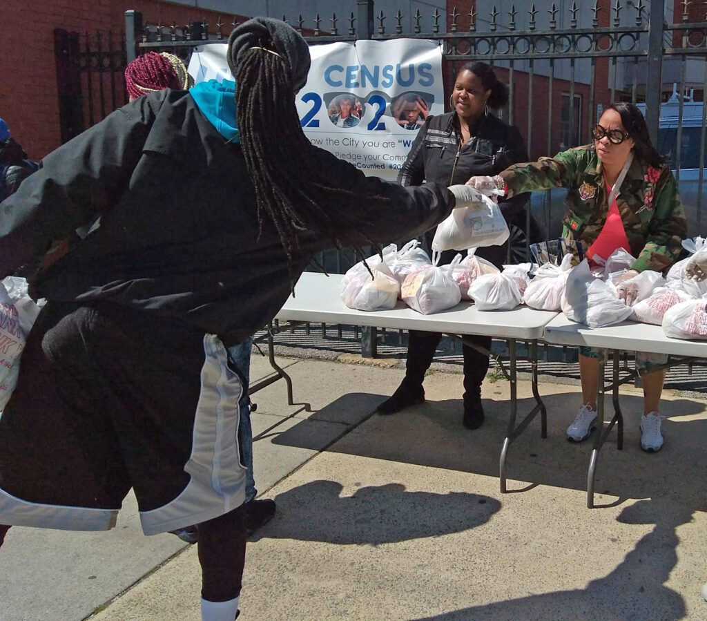 UPO members handing out aid bags to community members