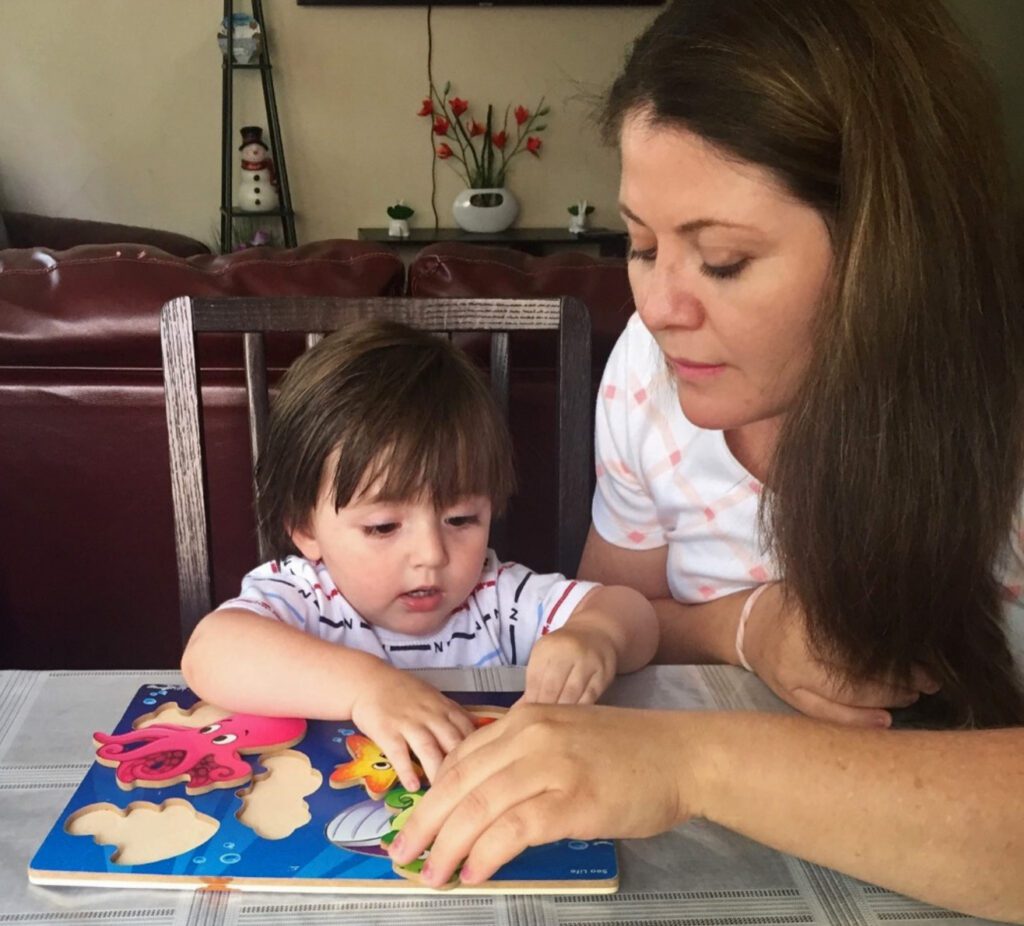 Mom and child playing with animal blocks