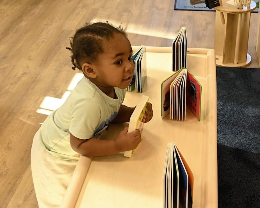 Young child holding a small book